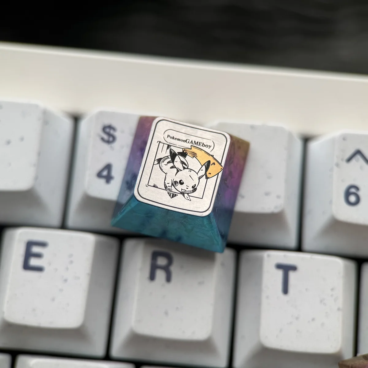 Pikachu titanium artisan ESC keycap from multiple angles, showcasing vibrant yellow, sleek anodized finish, and premium craftsmanship.