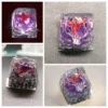 Gallery views of a handcrafted legendary Pokemon resin keycap, showcasing intricate mythical character details within translucent, vibrant resin.
