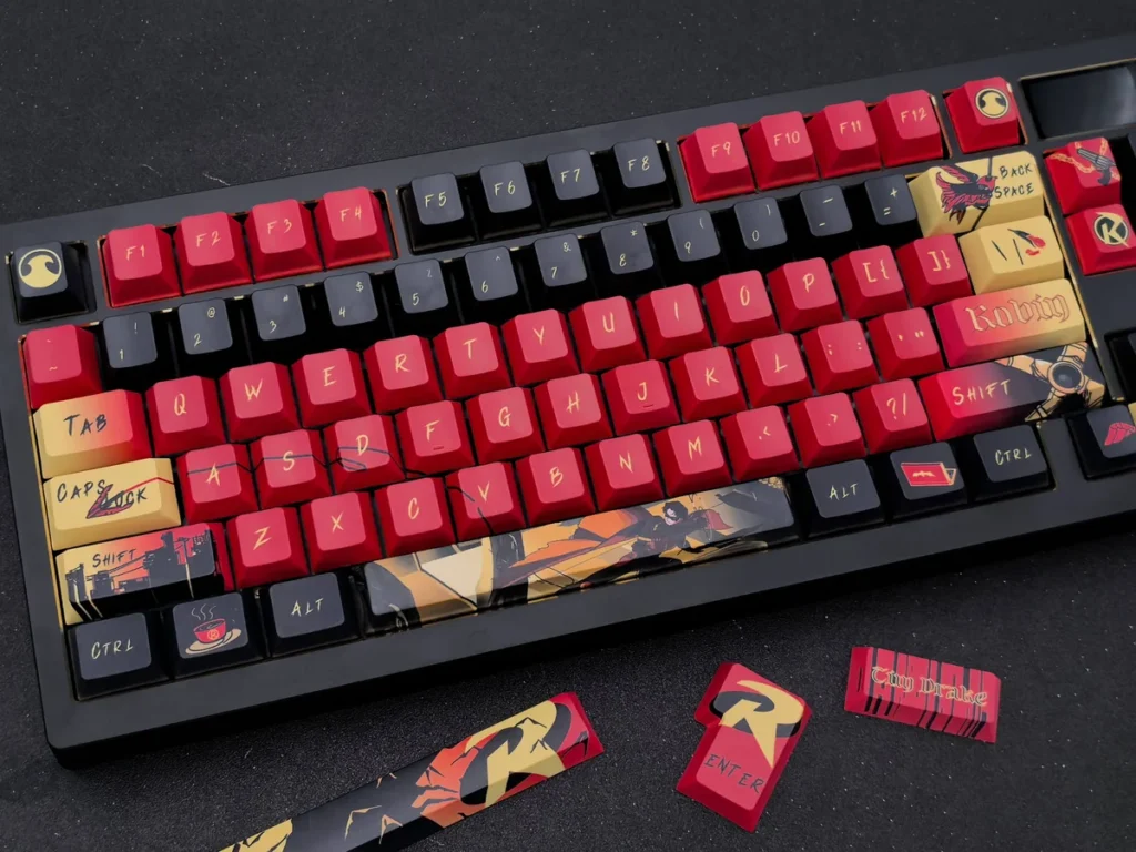 Striking Red Robin Vigilante keycaps set showcasing iconic DC motifs in a premium red and black design for mechanical keyboards.
