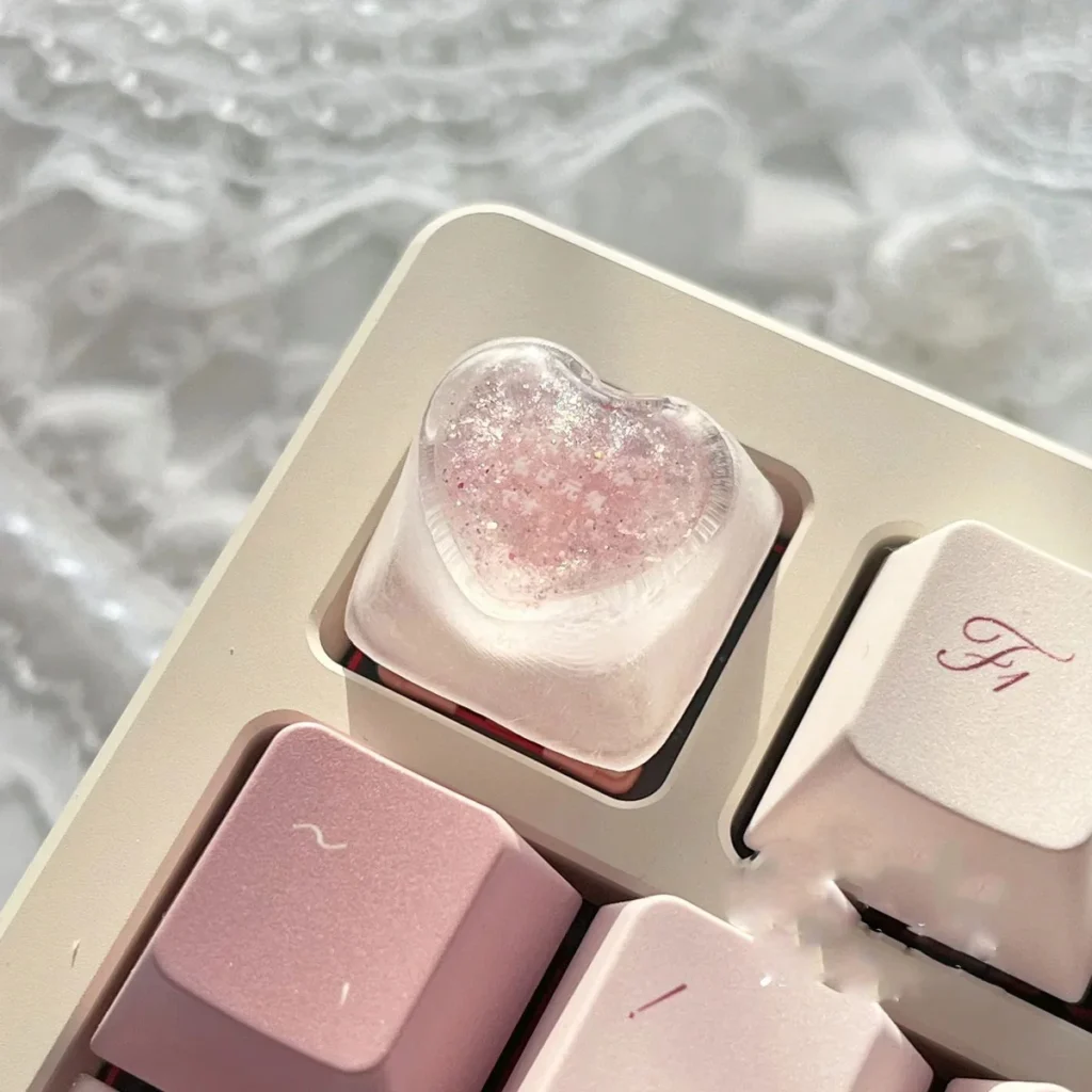 Gallery of handcrafted translucent resin heart keycap, showcasing its delicate design, embedded romantic hearts, and angelic motifs from various angles.