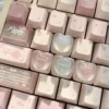 Handcrafted translucent resin heart keycap, a delicate main display showcasing romantic embedded hearts and angelic motifs for an artistic keyboard.