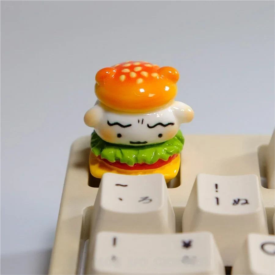 Handcrafted Crayon Shin-chan Shiro artisan keycap, whimsically sculpted from resin featuring Shiro in a delightful hamburger design for a playful keyboard.