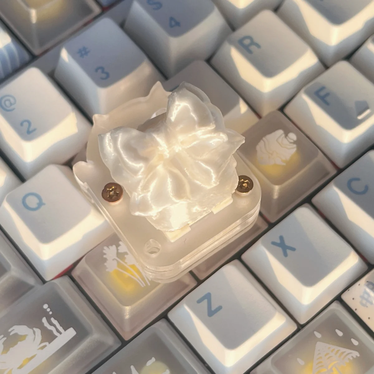 Ethereal handcrafted silk butterfly keycap shown from multiple angles, showcasing its delicate silk bow artisan detail. A whimsical, high-quality accessory.