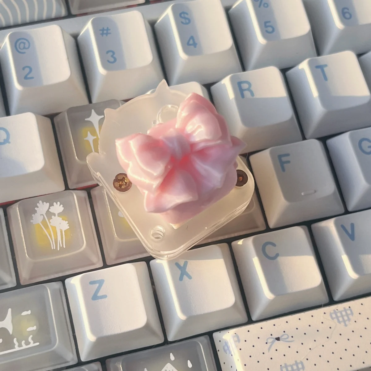 Close-up images of the ethereal handcrafted silk butterfly artisan keycap, showcasing delicate silk bow details and whimsical garden fantasy design.