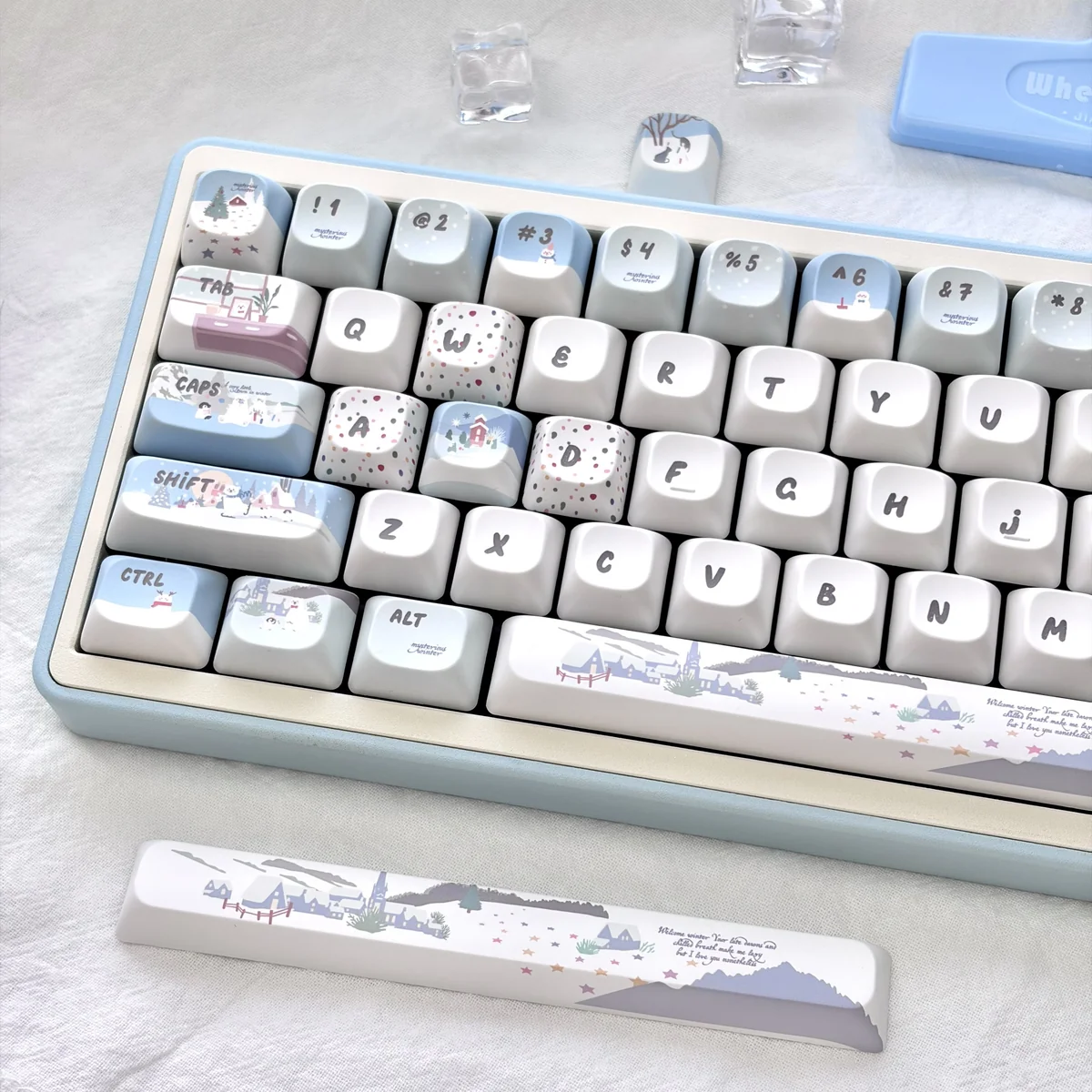 Whimsical snowman mechanical keycaps from various angles. Shows playful blue and white winter wonderland designs, charming snowmen and snowflakes.