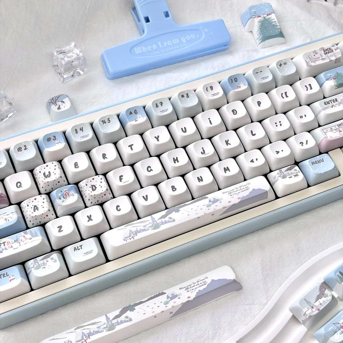 Whimsical snowman mechanical keycap from a unique angle, showcasing its playful blue and white winter wonderland design with charming snowmen.