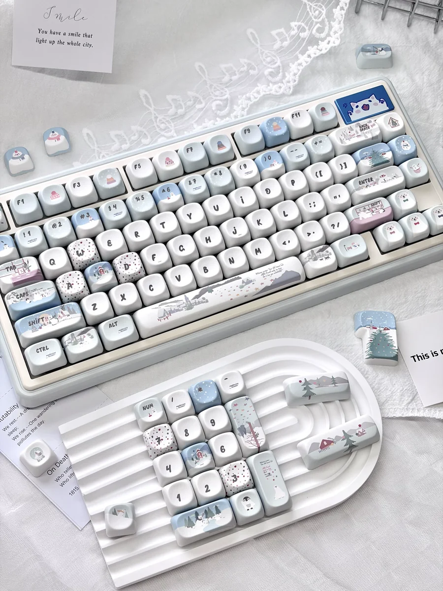 Whimsical little snowman mechanical keycaps, showcasing a charming blue and white winter wonderland design with playful snowflake accents.