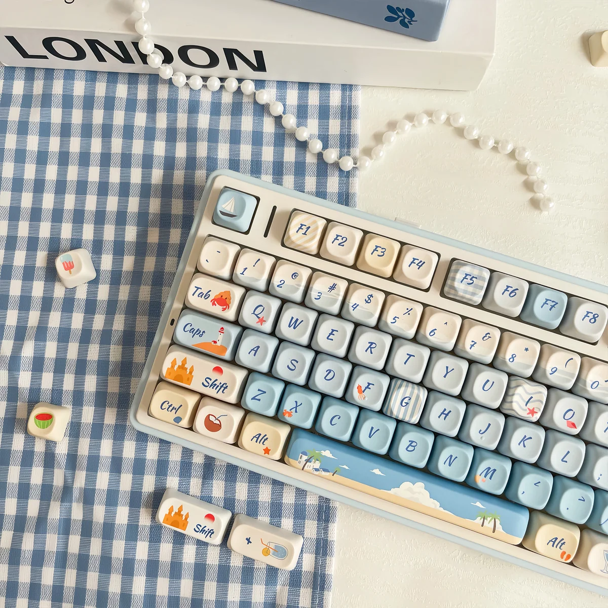 Angled close-up of Serene Summer Beach PBT dye-sub keycaps set, showcasing vibrant sun-drenched beach and azure ocean motifs for a tranquil escape.