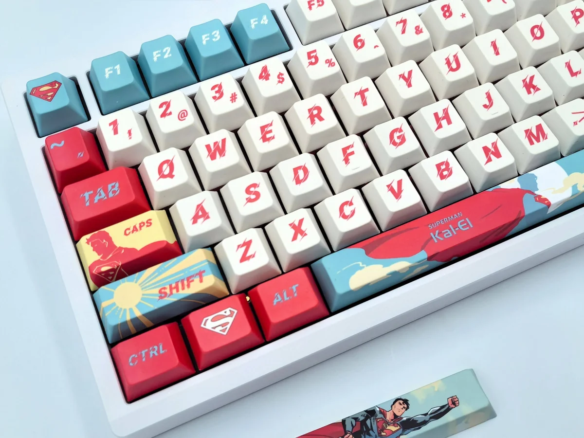 Detailed views of exclusive full-set DC Superman keycaps set, showcasing vibrant red and blue, the classic Superman emblem, and heroic comic book aesthetics.