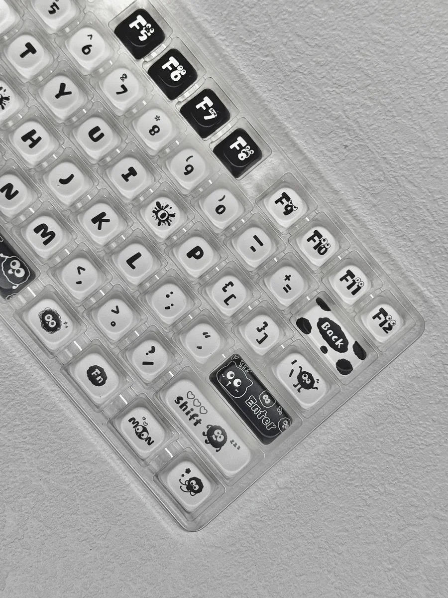 Ghibli Susuwatari PBT Dye-sub Keycaps set from various angles. High-quality keycaps with enchanting dark characters, evoking playful nostalgic design.