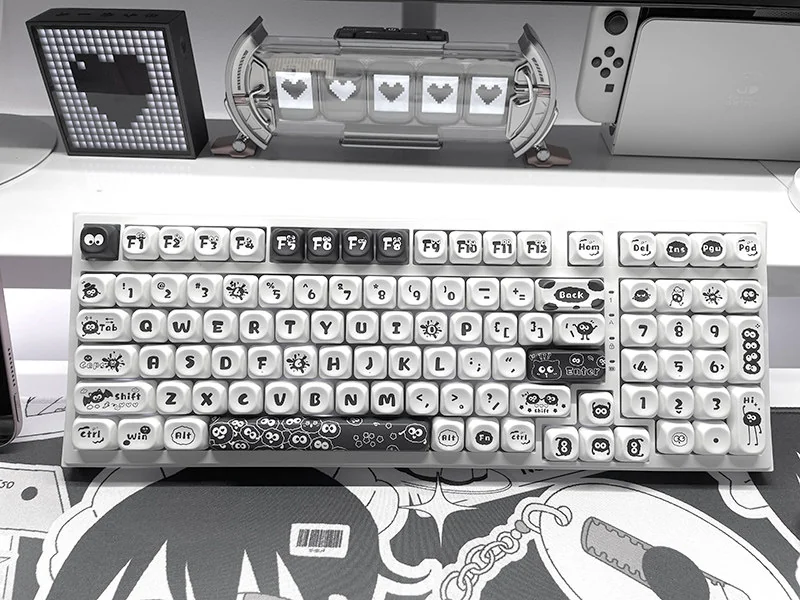 Whimsical Ghibli Susuwatari PBT dye-sub keycaps set. Multiple angles highlight playful characters, durable PBT, and vibrant dye-sub quality, evoking purely design.