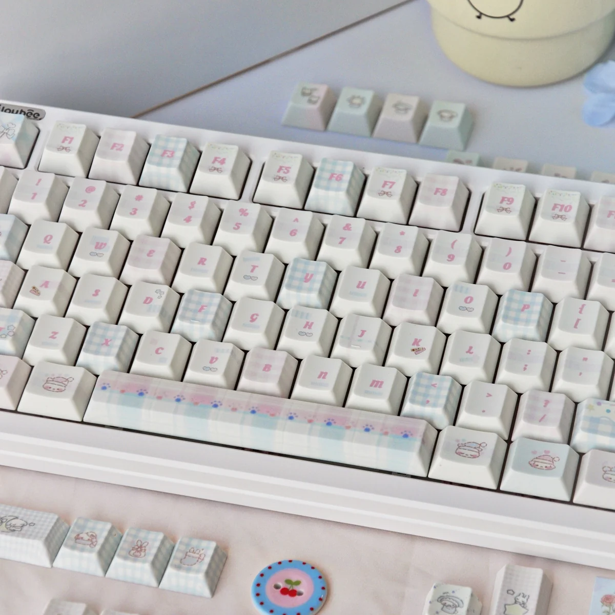Delightful Sweet Marshmallow PBT dye-sub keycaps set, featuring soft pastel colors and whimsical designs viewed from different perspectives.