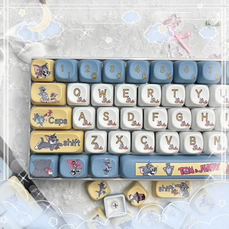 Vibrant Tom & Jerry PBT Dye-Sub keycaps set, showcasing iconic cartoon characters from various angles. This playful 108-key MOA profile set brings whimsy.