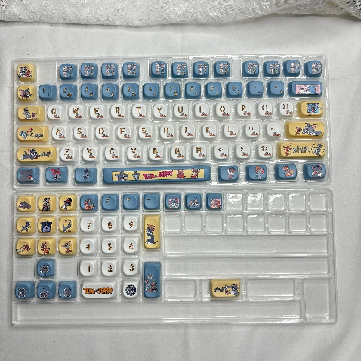 Close-up of the iconic Tom & Jerry PBT Dye-Sub keycaps set, highlighting the vibrant, whimsical characters on the durable 108-key MOA profile.