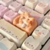 Whimsical hand-sculpted lounging cat keycap in a gallery of views, featuring the charming miniature feline on its cozy, colorful sofa.
