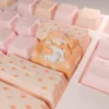 Hand-sculpted artisan cat keycap. Whimsical lounging feline on a cozy, colorful sofa, shown from angles. Charming miniature artistic design.