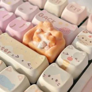 Whimsical hand-sculpted artisan cat keycap featuring a charming miniature lounging feline on a cozy, colorful sofa, viewed from various angles.
