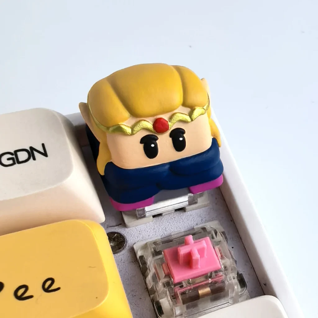 Main image of an iconic, handcrafted Zelda Keycap. Features an intricate 3D Princess Zelda resin sculpture with vibrant fantasy colors, capturing gamers favor.