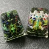 Close-up views of the handcrafted luminous resin Legendary Pokemon keycap, showcasing intricate sculptural details and vibrant translucent colors.