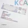 Cozy Afternoon Tea PBT side-printed luminous keycaps set, viewed from various angles, highlighting soft pastel colors, warm hues, and subtle tea motifs.