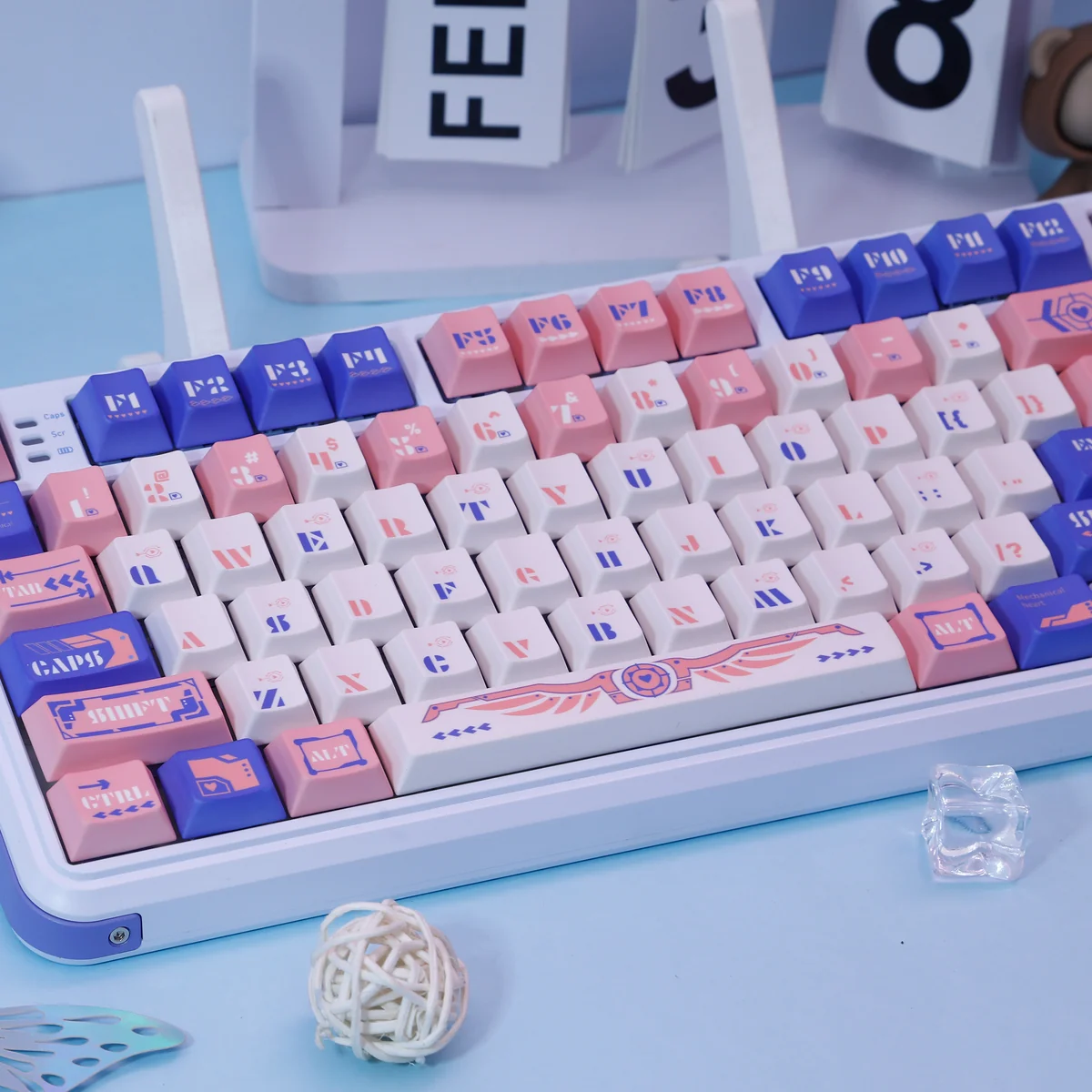 Artistic Mechanical Angel Keycaps set, beautifully crafted with ethereal blue and pink dye-sub PBT, featuring delicate celestial angel artwork from a unique angle.