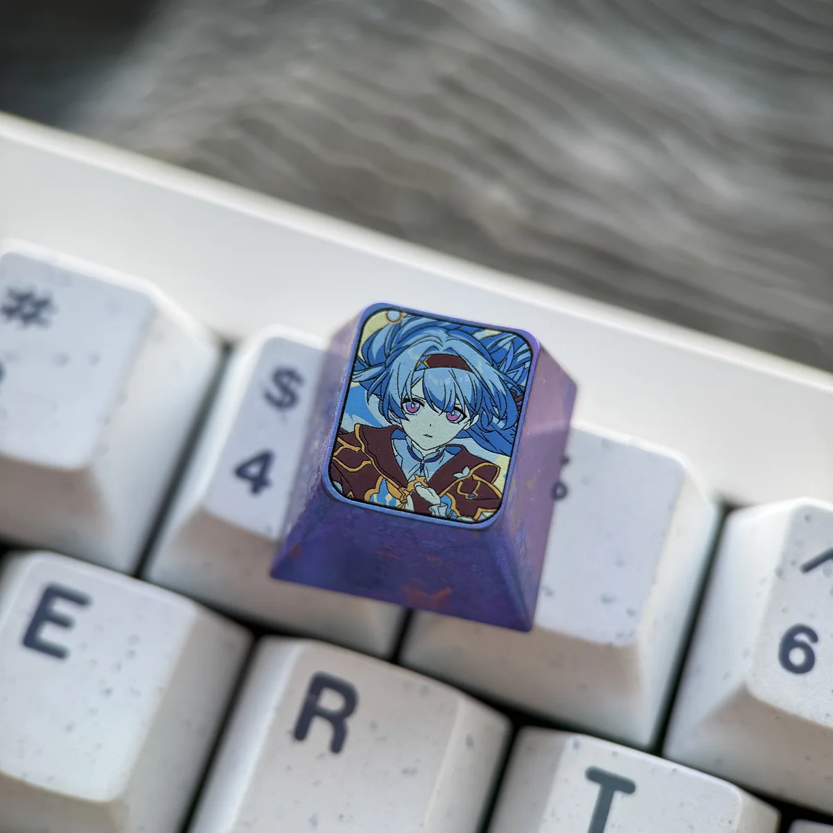 Handcrafted titanium artisan ESC keycap. Gallery views show its ethereal firefly design, vibrant iridescent colors, and metallic sheen.
