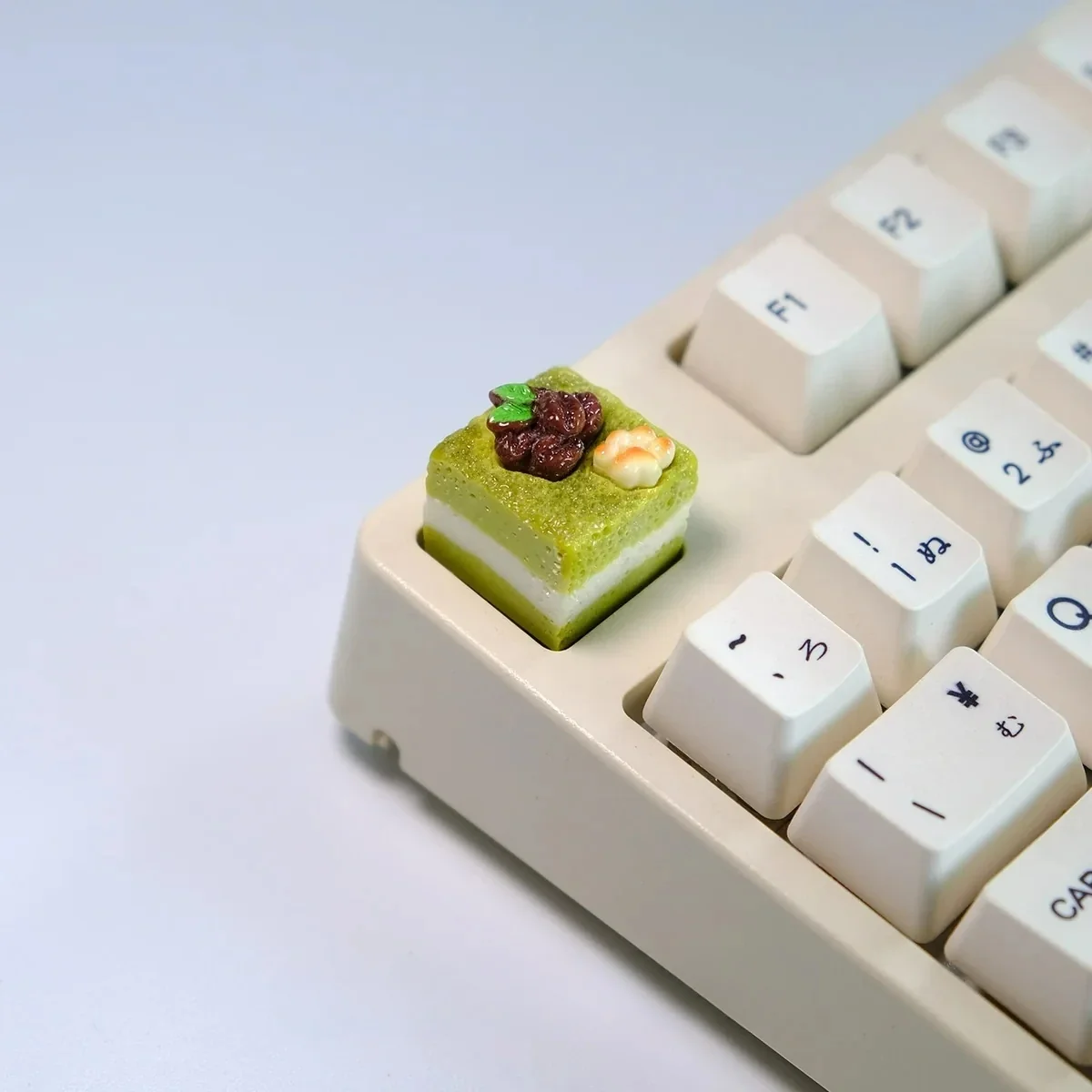 Handcrafted mousse cake artisan keycap from multiple angles, showcasing unique whimsical dessert design, vibrant pastel colors, and realistic texture.