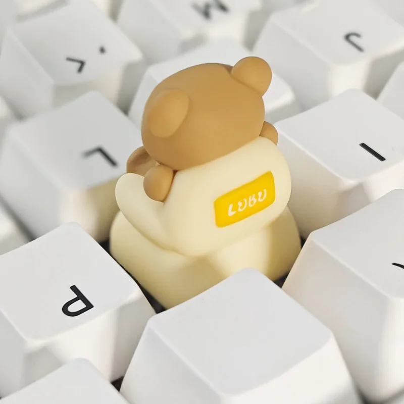 Whimsical Sofa Bear artisan keycap from multiple angles, showcasing its intricately crafted miniature resin scene and charming, playful design.
