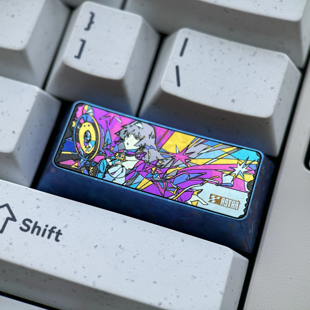 Astra Yao iridescent titanium artisan keycap from multiple angles, showcasing its shimmering cosmic patterns and handcrafted premium finish.