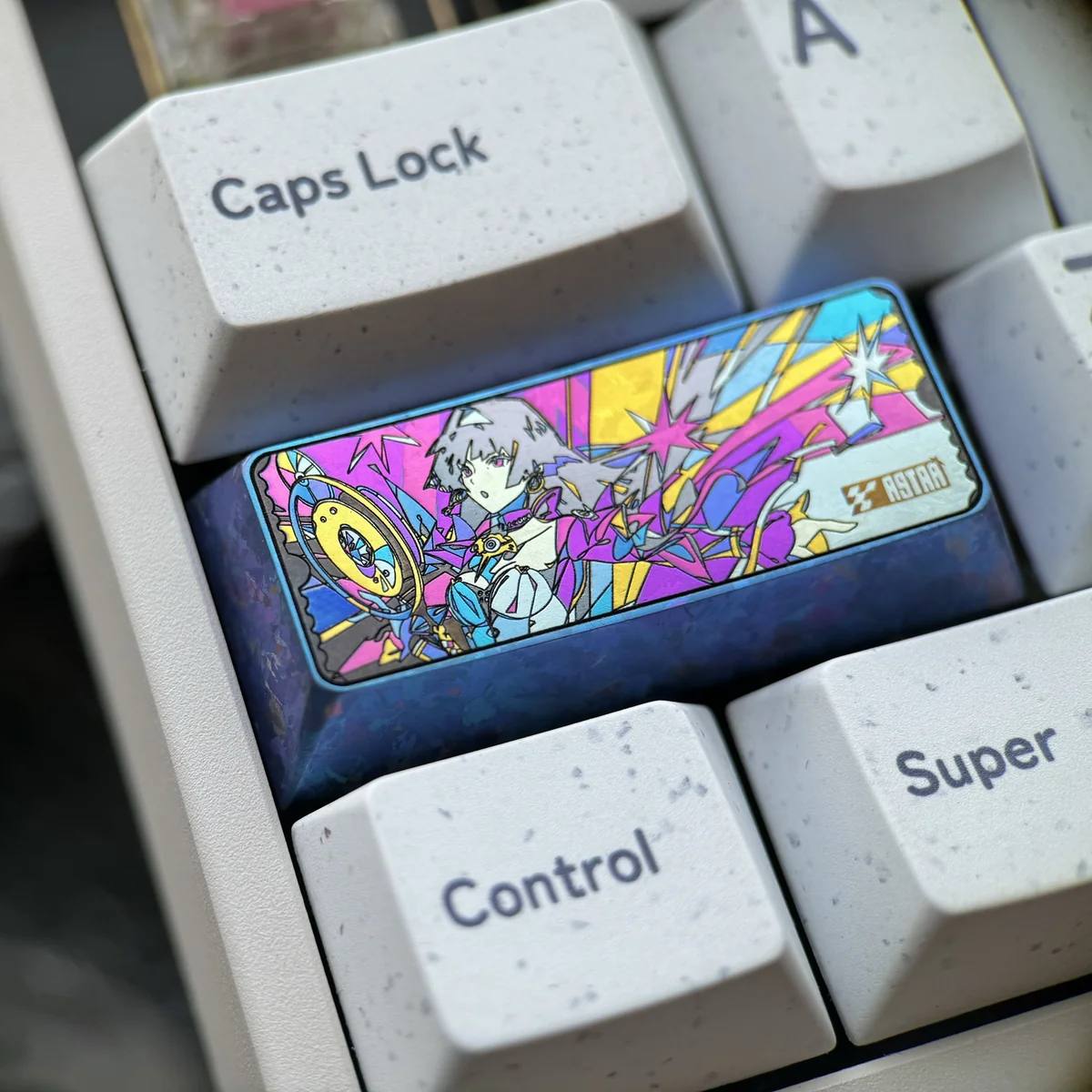 Astra Yao handcrafted iridescent titanium keycap, displaying its unique cosmic art and shimmering premium finish from various angles.