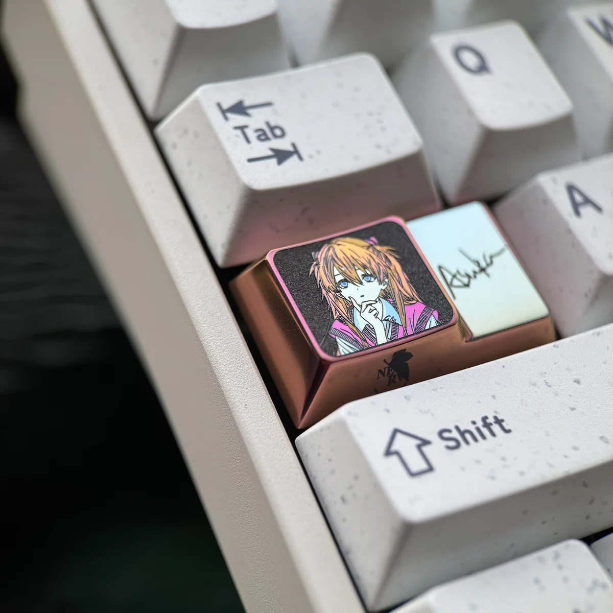 Angled shot of 1.75U custom Caps Lock key with Asuka art, made from durable titanium for mechanical keyboards.