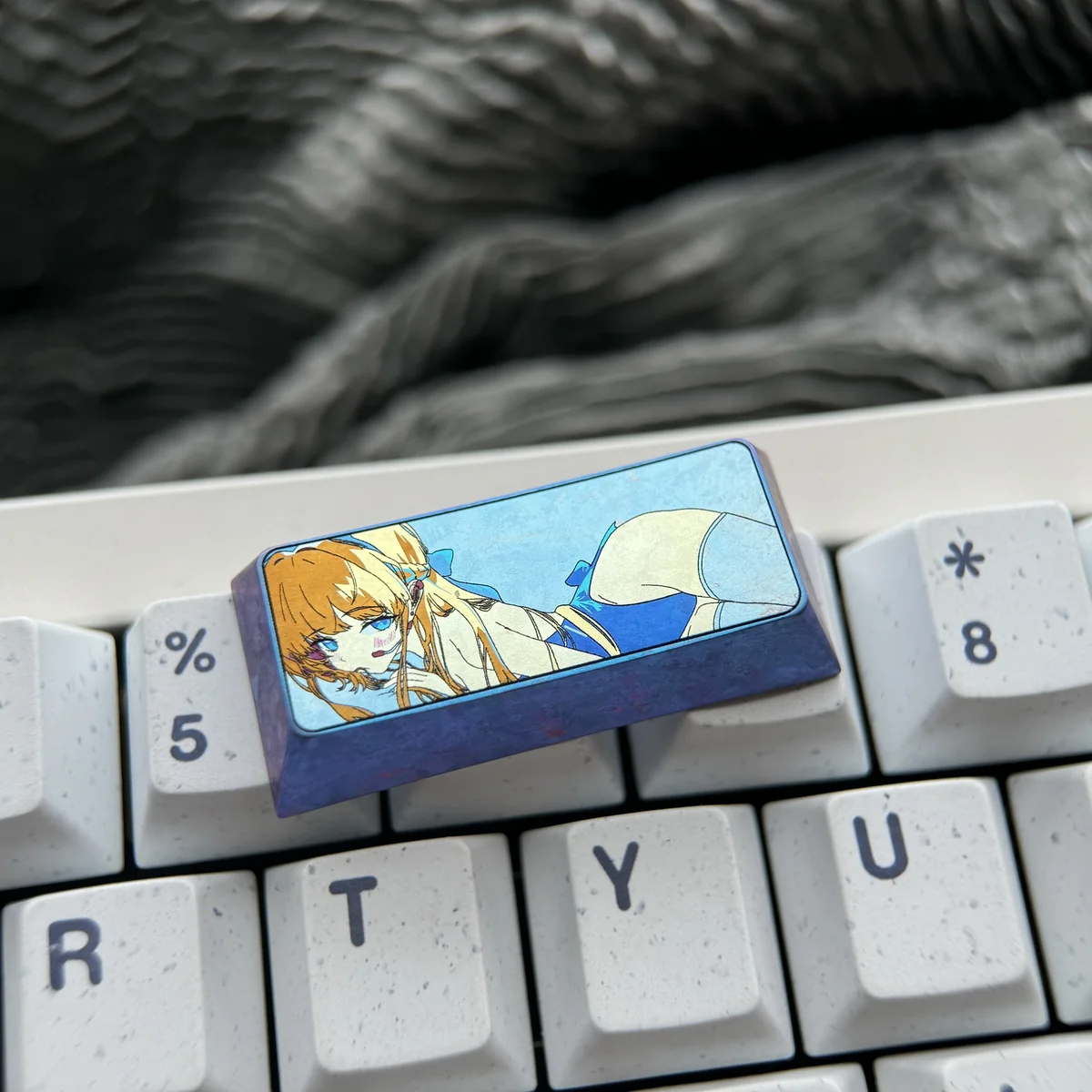 A gallery of meticulously crafted vibrant anodized Asuma Toki Titanium keycaps, showcasing sleek metallic designs and multi-tone colors from various angles.