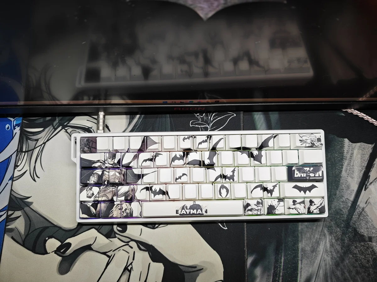 Close-up of the iconic Batman side-engraved PBT keycaps set, revealing the subtle shine-through legends with a mysterious Gotham glow.