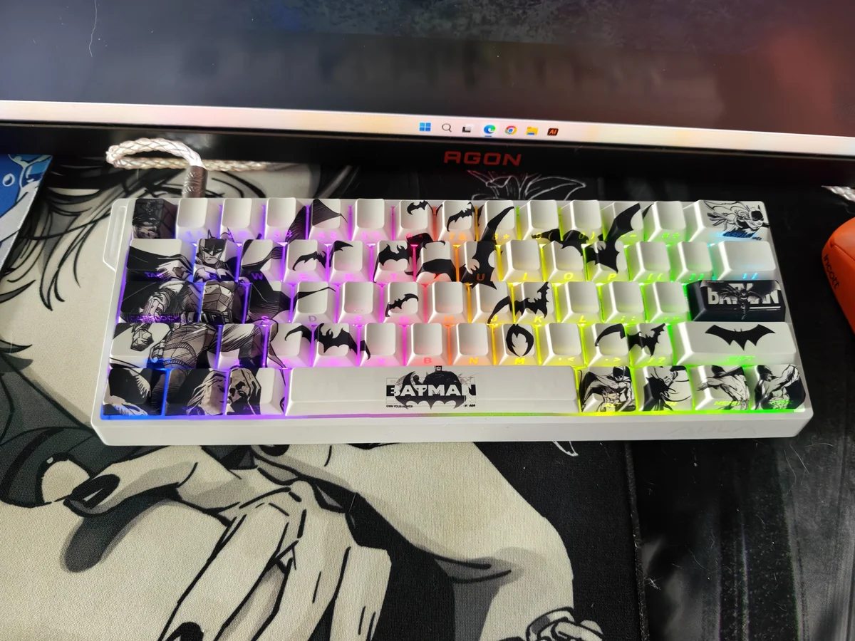 Close-up views of the iconic Batman side-engraved PBT keycap set, highlighting the mysterious Gotham aesthetic and subtle shine-through legends from various angles.