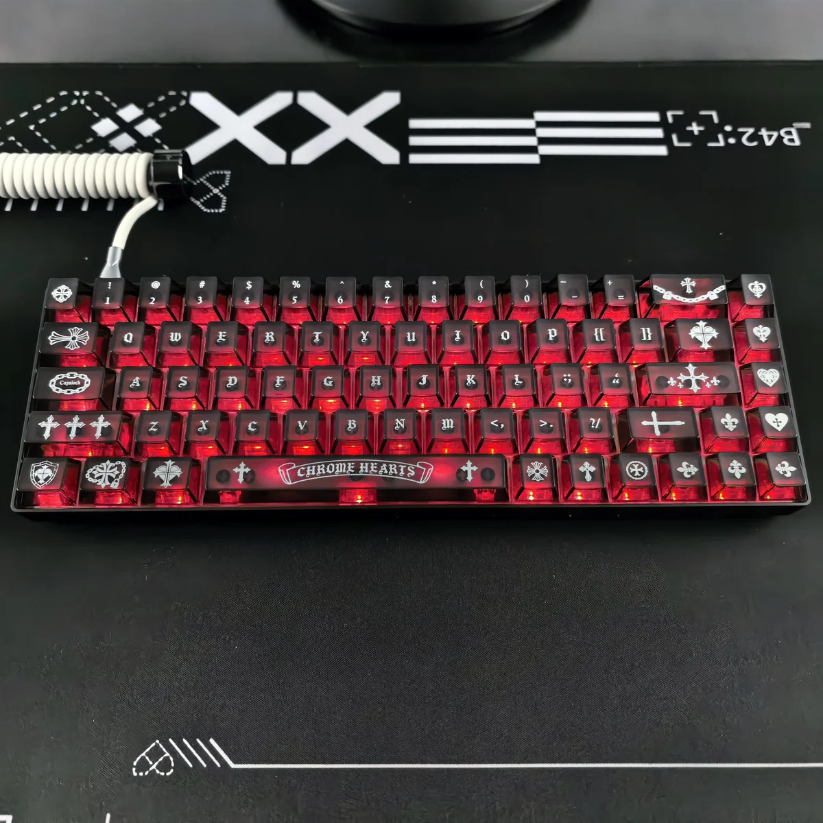 Close-up gallery of a Gothic Chrome Hearts frosted PC keycap set, highlighting its edgy design, translucent finish, and potential RGB glow from various angles.