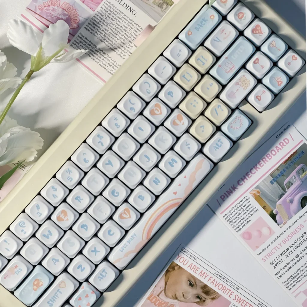 Love Diary PBT Keycaps Set: A dreamy pastel pink and blue set with playful romantic symbols and an ergonomic XDA/MOA profile for a charming typing experience.