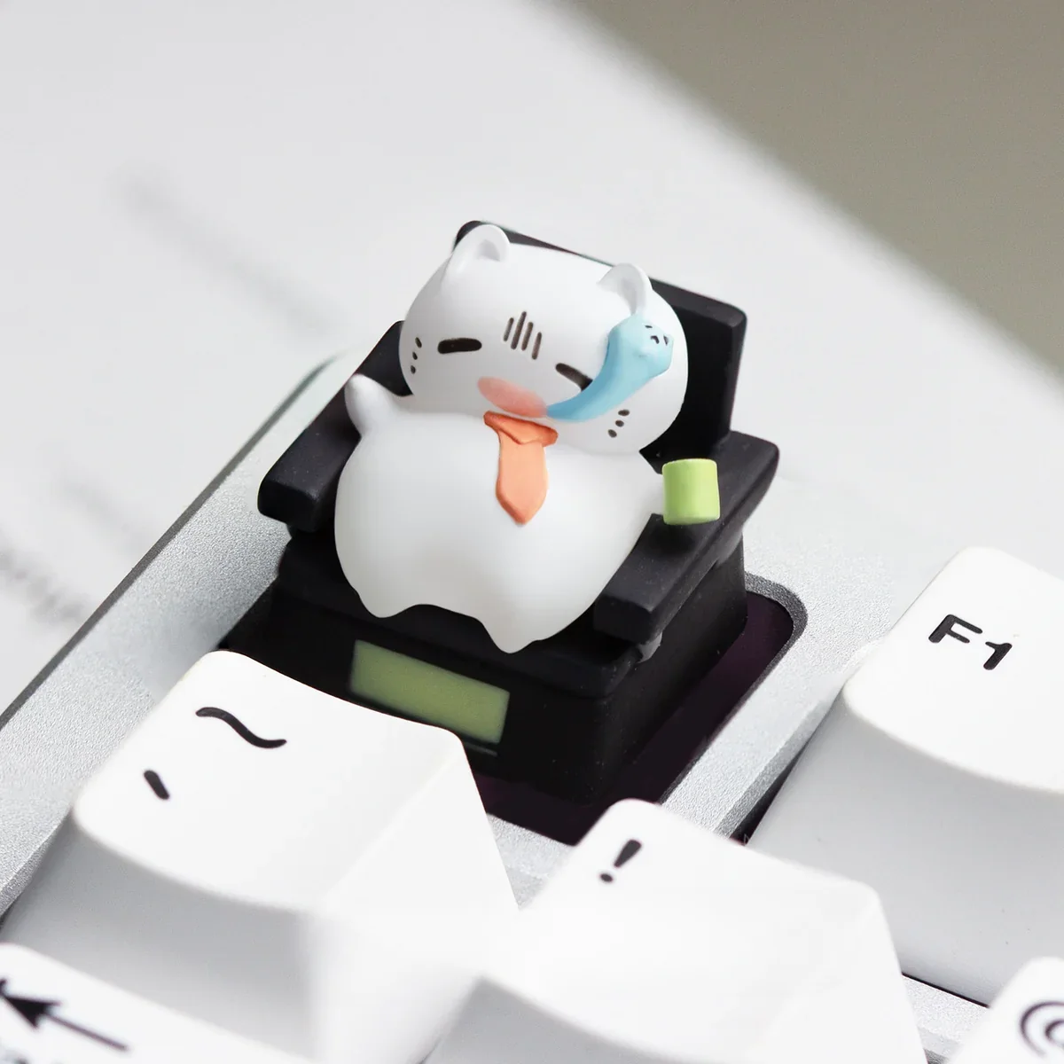 Multiple angles of a handcrafted resin Cat Worker artisan keycap for the ESC key, featuring the charming sculpted cat in playful office scenarios.