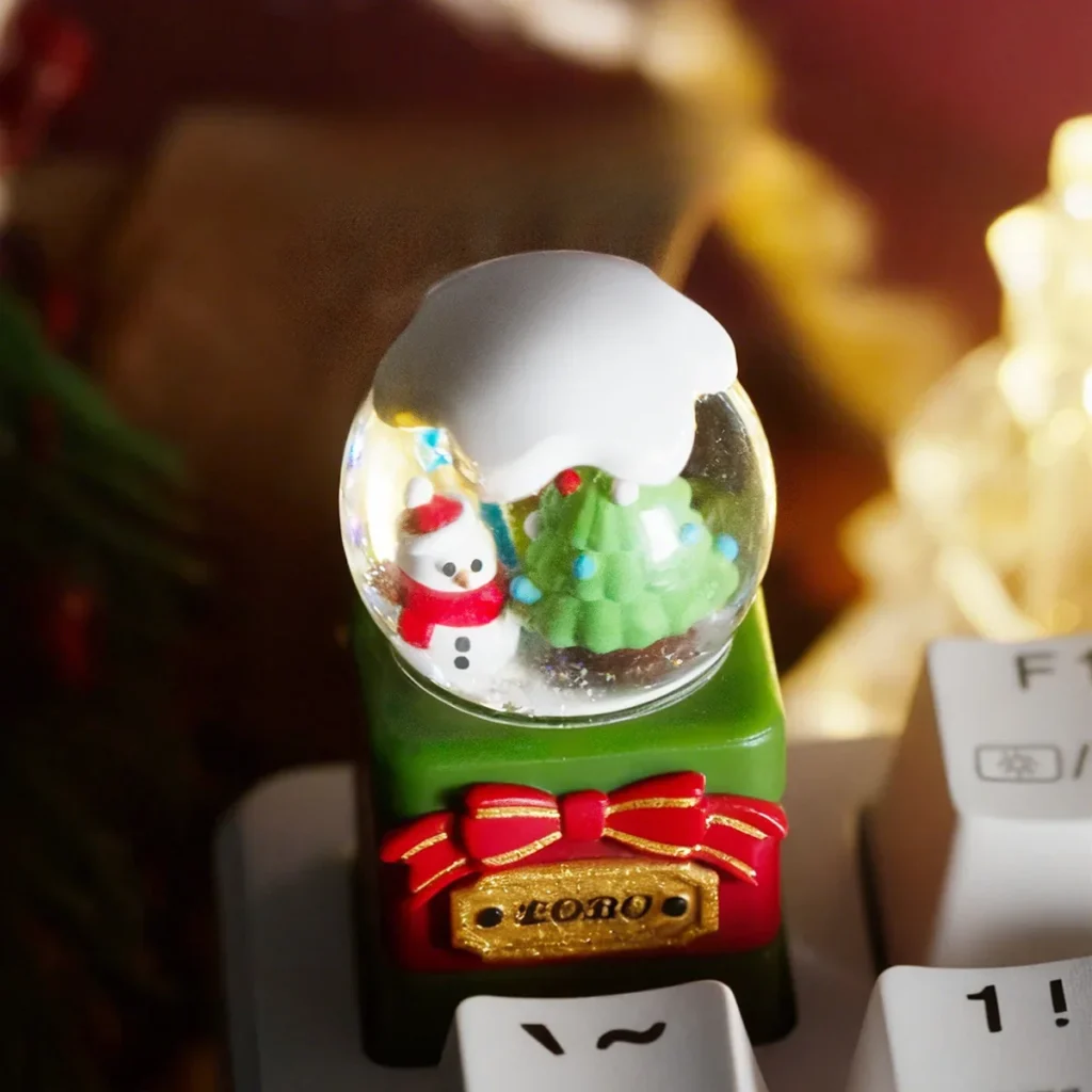 Multiple views of a handcrafted artisan Christmas crystal ball resin keycap, revealing its intricate miniature Christmas wonderland from diverse artistic.