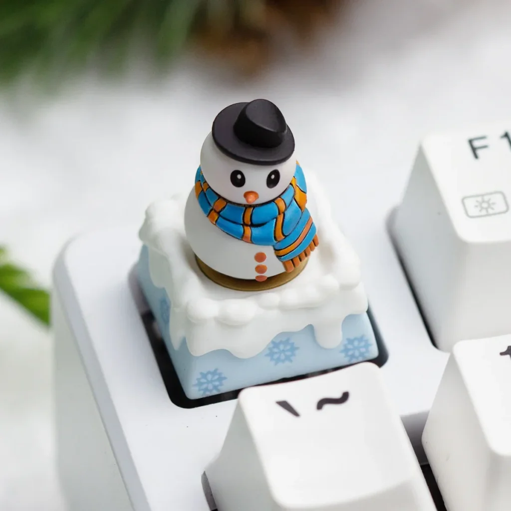 Multiple angles of a handcrafted resin Christmas artisan ESC keycap, showcasing its blue winter wonderland theme with encased festive details.