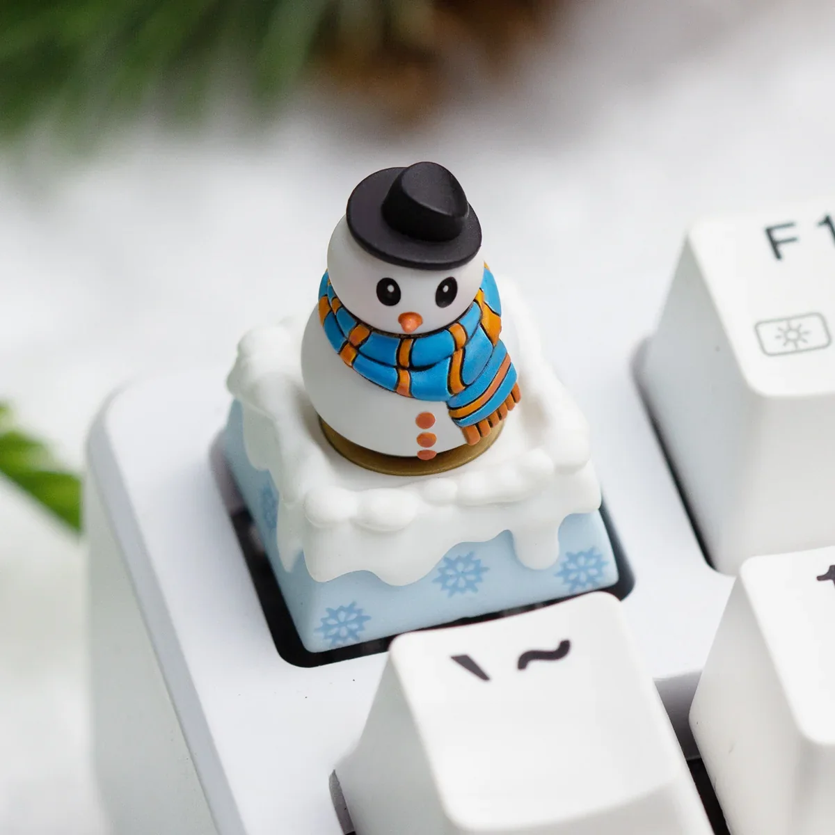 Multiple angles of a handcrafted resin Christmas artisan ESC keycap, showcasing its blue winter wonderland theme with encased festive details.