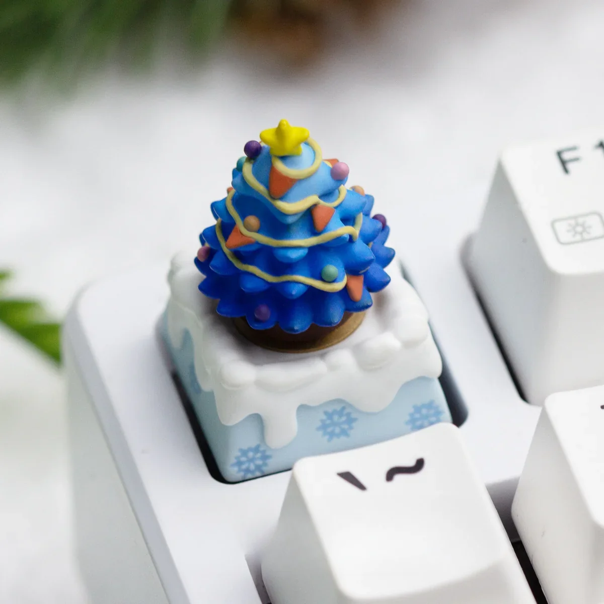 Handcrafted resin Christmas ESC keycap, showcasing its blue winter wonderland design and festive details from various artistic angles.