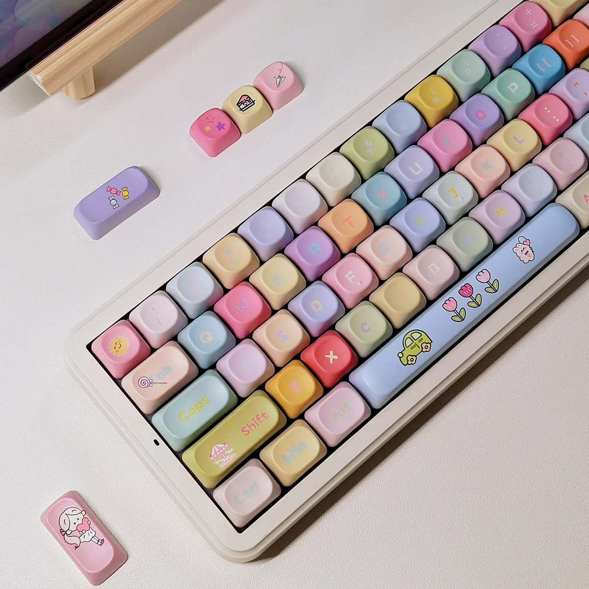 Dopamine PBT dye-sublimated keycap set, displaying vibrant candy colors and whimsical carousel and windmill motifs from various angles, evoking joyful design.