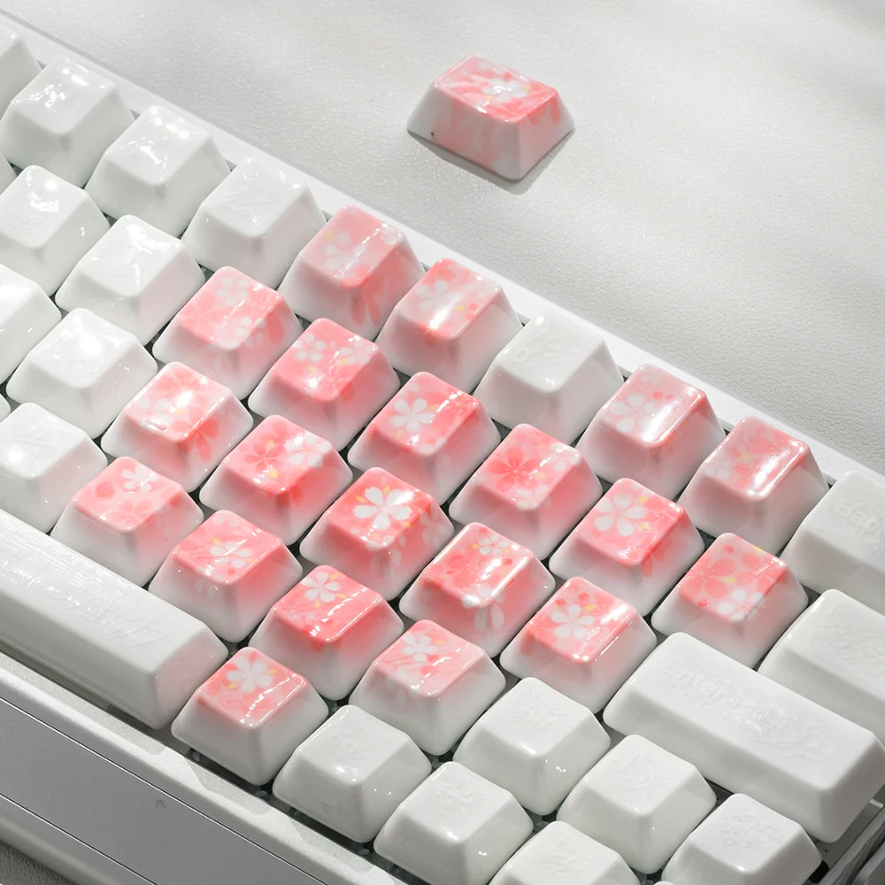 Close-up of a 21-piece custom keycap set with heart and cherry blossom designs.