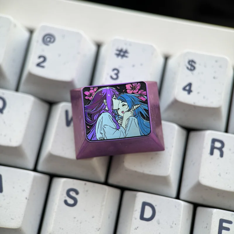 Premium Frieren Fern titanium artisan keycap, prominently displaying intricate anime character designs on anodized titanium. A stunning Frieren keycap.