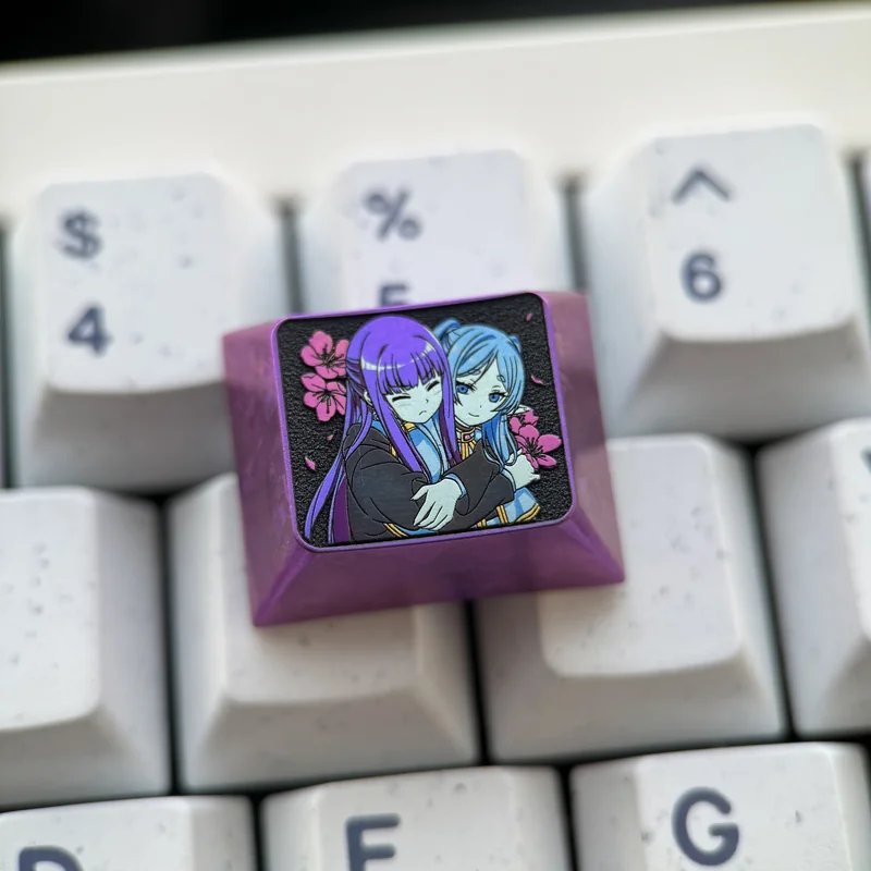 Premium Frieren Fern titanium artisan keycaps, intricately designed with anime characters, displayed from multiple angles to highlight the anodized titanium material.