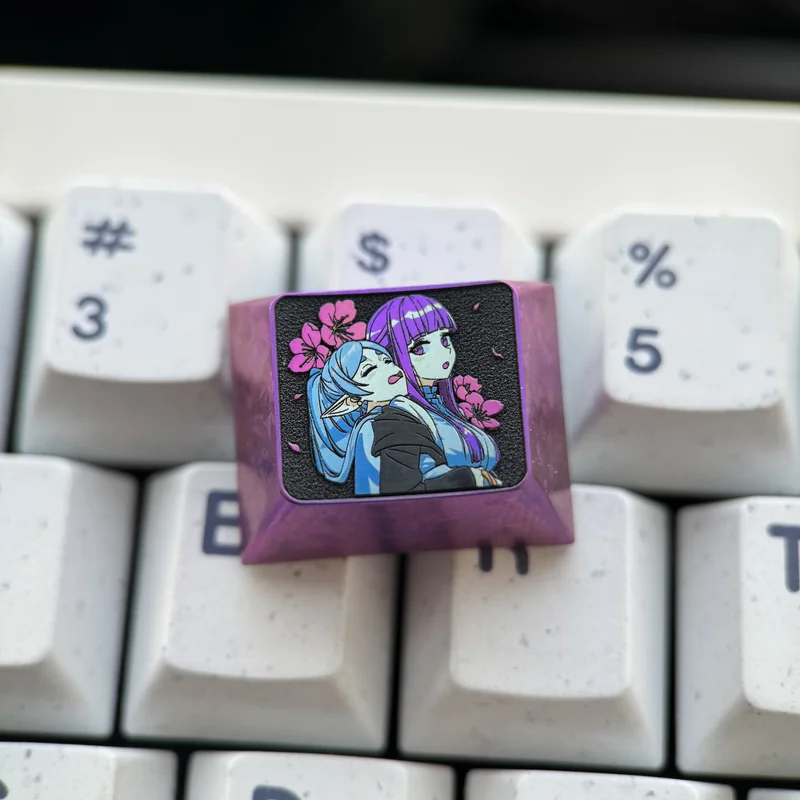 Premium Frieren Fern titanium artisan keycap, prominently displaying intricate anime character designs on anodized titanium. A stunning Frieren keycap.