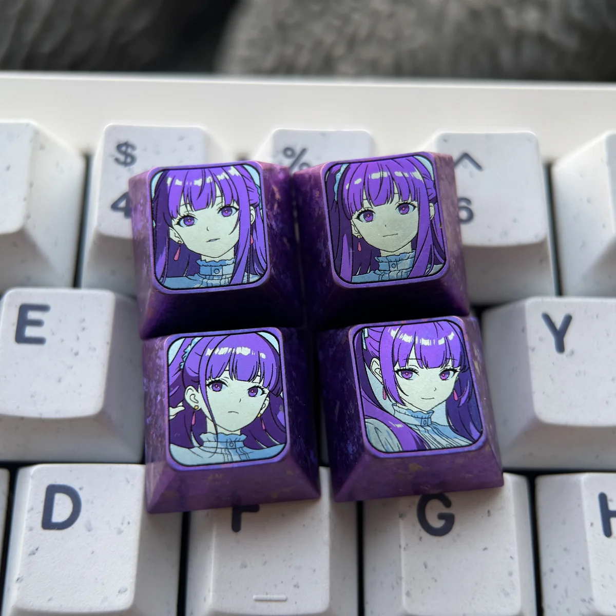 Exquisite Frieren titanium artisan keycap showcasing its intricate Frieren-themed design, vibrant anodized colors, and luxurious texture from various angles.