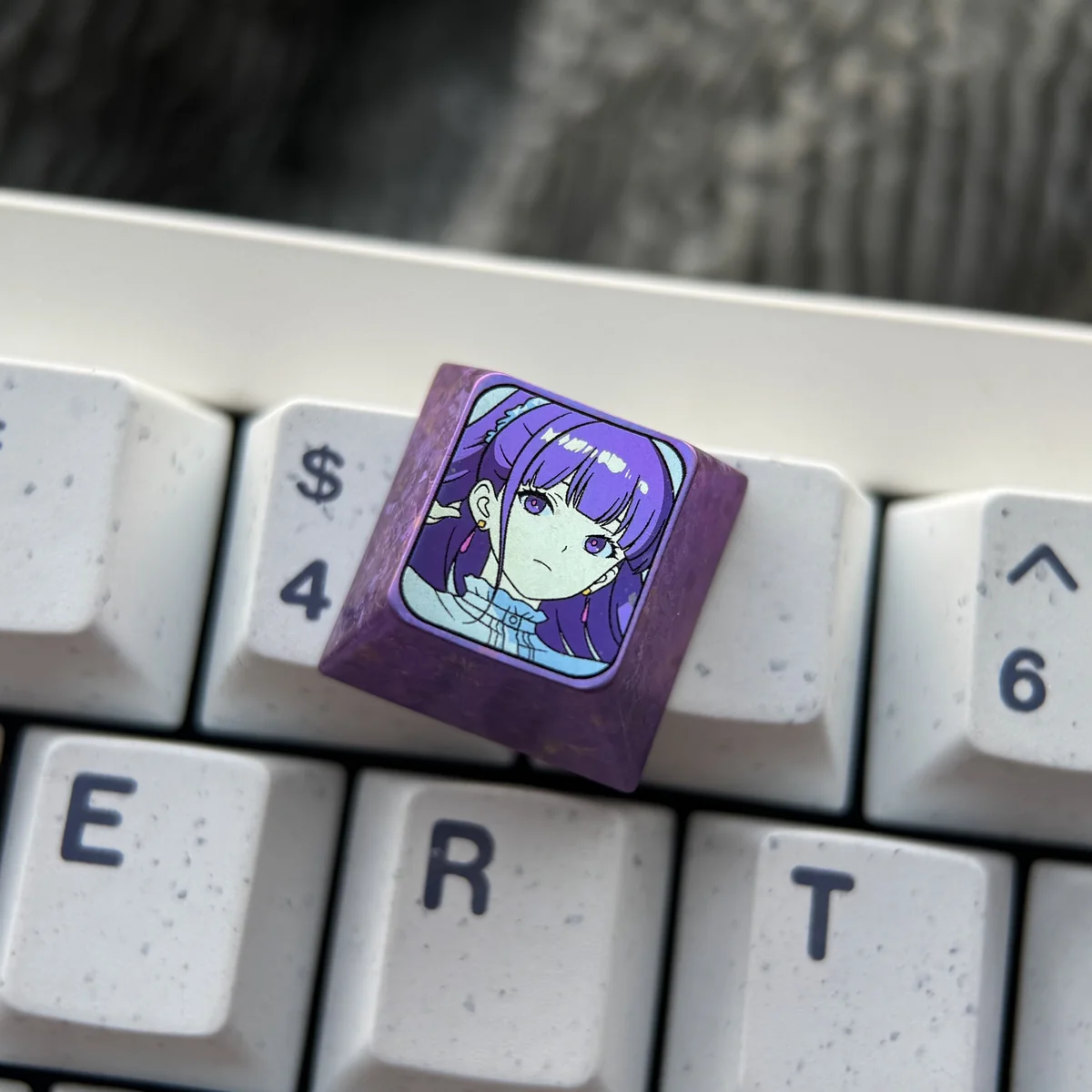 Multiple angles of the exquisite Frieren titanium artisan keycap, featuring Frieren-inspired design, vibrant colors, and luxurious titanium texture.