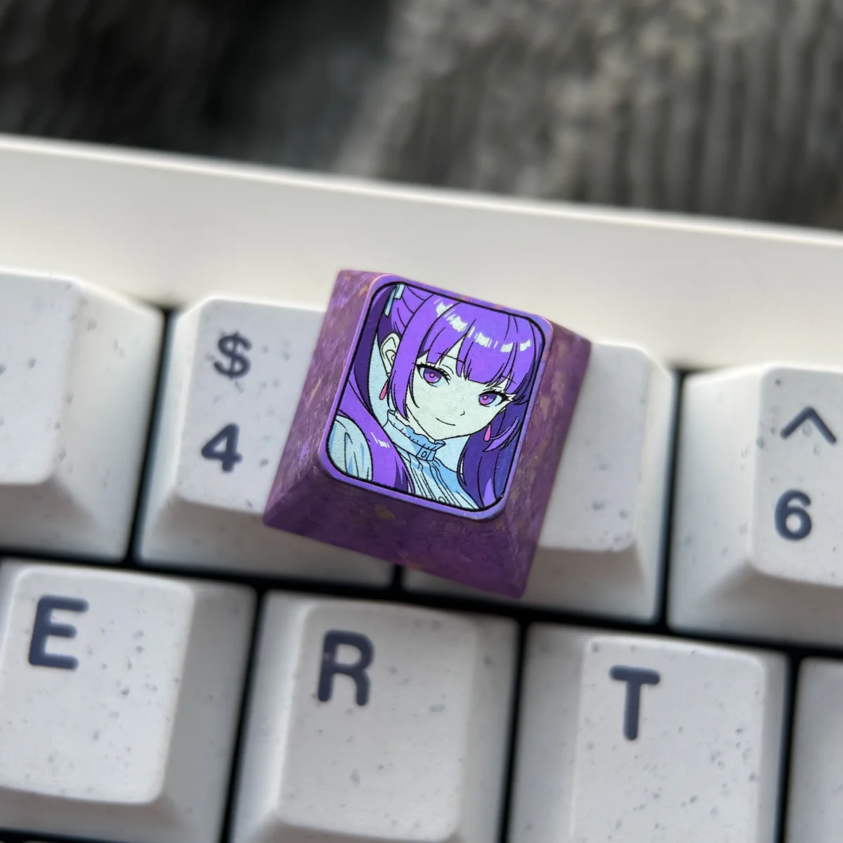 Frieren Titanium Artisan Keycap showcased from different angles, revealing exquisite Frieren-inspired designs, vibrant anodized colors, and luxurious design.