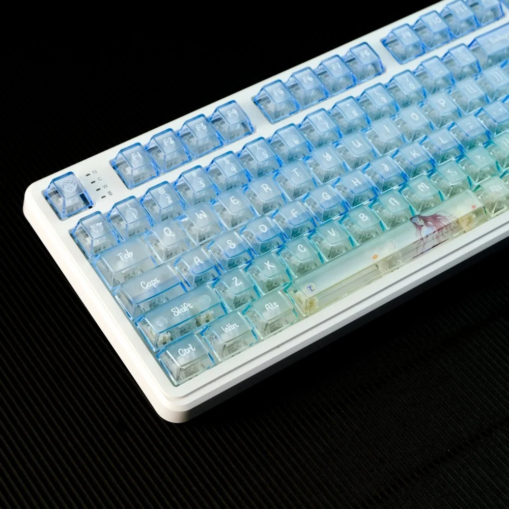 Multiple views of the Sea Salt Frosted PC Gradient Keycaps Set, highlighting the ocean-inspired blue-white gradient and ethereal frosted translucent finish.